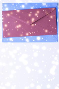 Greetings, postal service and online newsletter concept - Winter holiday blank paper envelopes on marble with shiny snow flatlay background, love letter or Christmas mail card design