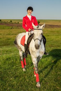 The sportswoman on a horse. The horsewoman on a red horse. Equestrianism. Horse riding racing. Rider on a horse.