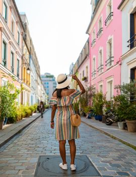 Young women on a city trip in Paris visiting the colorful streets in Paris, Cremieux Street Rue Cremieux, Paris, France.