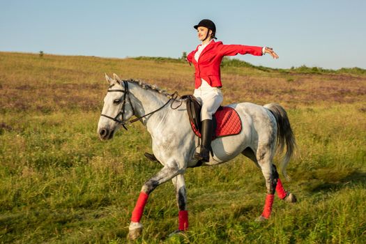 The sportswoman on a horse. The horsewoman on a red horse. Equestrianism. Horse riding racing. Rider on a horse.