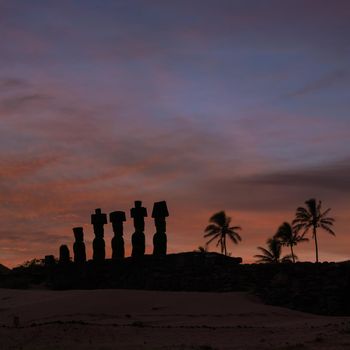 Silhouette shot of Moais at Anakena beach in Easter Island Chile sunrise