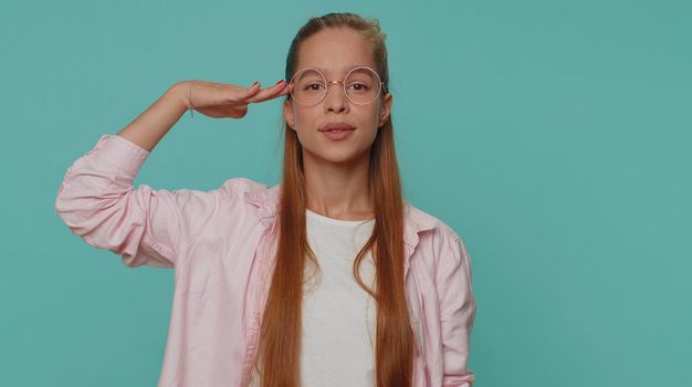 Yes sir. Subordinate, responsible serious teenager young girl giving salute listening to order as if soldier, following discipline, obeying, expressing confidence. Student child kid on blue background