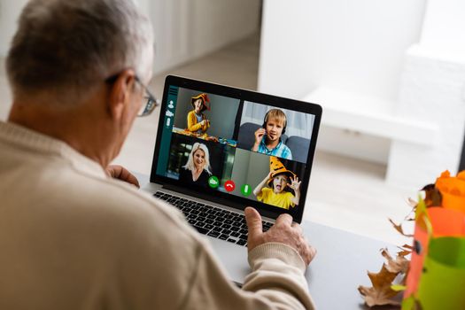 elderly man with laptop and video from grandchildren.