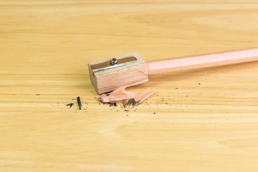 pencil and pencil sharpener on wood table