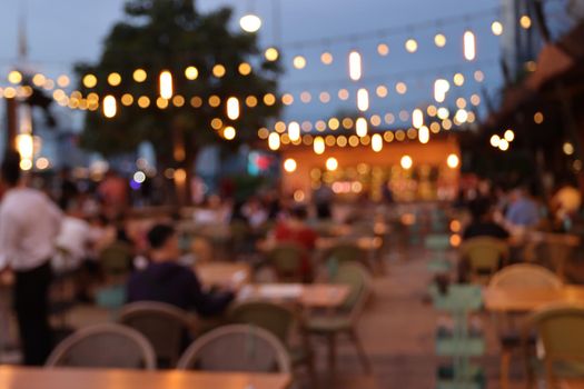 blurred image at the restaurant night time, many people in the restaurant eat and party happy relaxing 