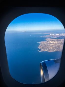 Travel, cloudscape and natural environment concept - View from the airplane window, sky and ocean blue