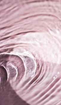 Pink flowing water texture as an abstract background - colourful liquids and creative designs concept. Pink flow