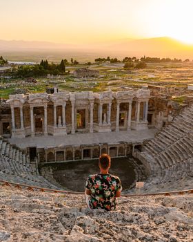 Hierapolis ancient city Pamukkale Turkey, a young men watching the sunset by the ruins Unesco site during summer