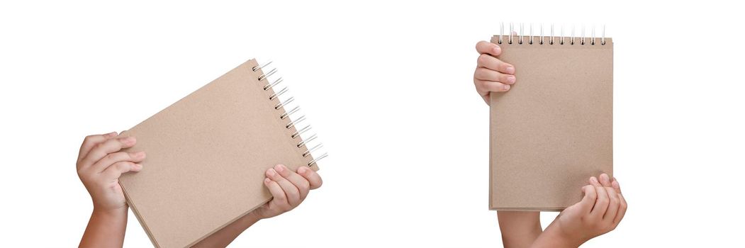 Notepad isolated on white background. Brown notepad made from recycled paper on a white background in the hands of a child.