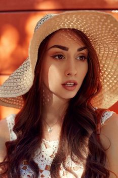 Sunny lifestyle fashion portrait of young stylish hipster woman walking on the street, wearing trendy outfit, straw hat, travel.