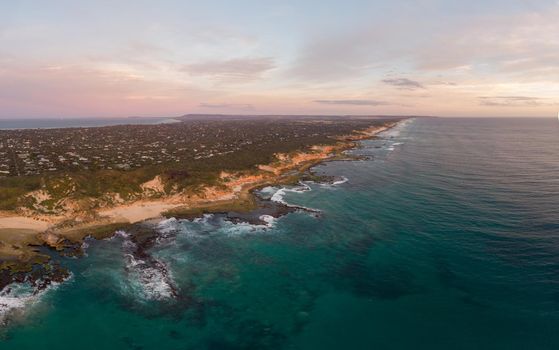 An aerial shot of Mornington Peninsula towards Point Nepean and Port Phillip Bay at sunset in Victoria, Australia