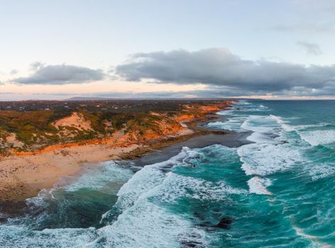 An aerial shot of Mornington Peninsula towards Point Nepean and Port Phillip Bay at sunset in Victoria, Australia