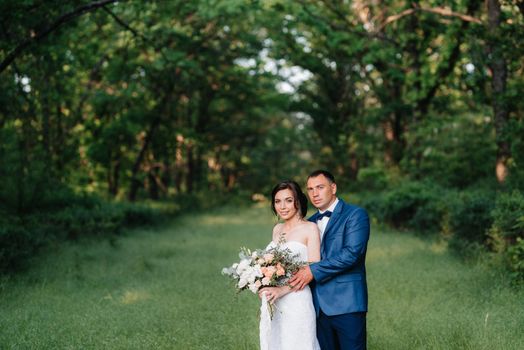 A couple in love a guy and a girl on a walk in the forest belt