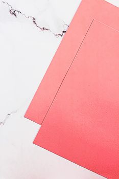 Pink A4 papers on white marble background as office stationery flatlay, luxury branding flat lay and brand identity design for mockups