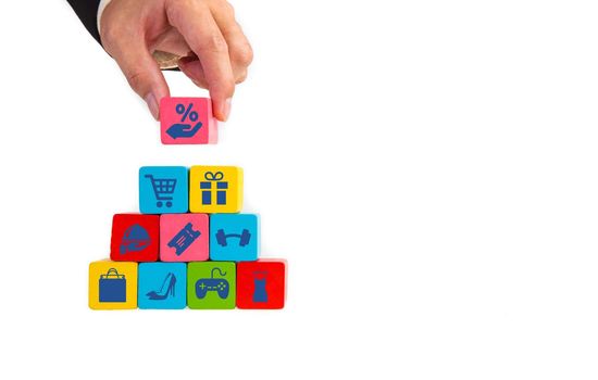 Businessman hand take wooden cube with shopping sales icon. Shopping concept.