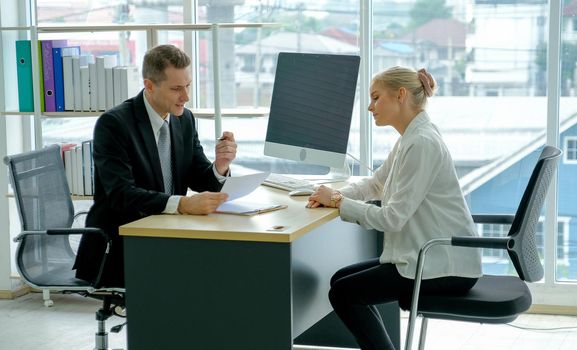 Business man talk with young woman during job interview for the company.