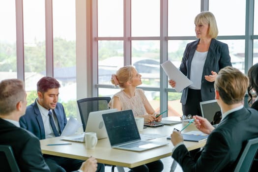 Manager woman or leader of business teams discuss with detail in the document with her team and plan for company project.