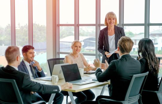 Manager woman or leader of business teams discuss with detail in the document with her team and plan for company project.