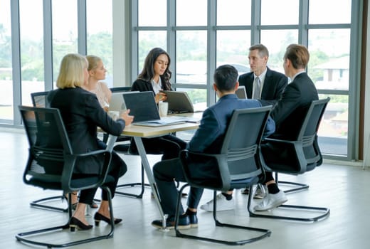 Business man discuss with his team about the project with their meeting and they look happy.