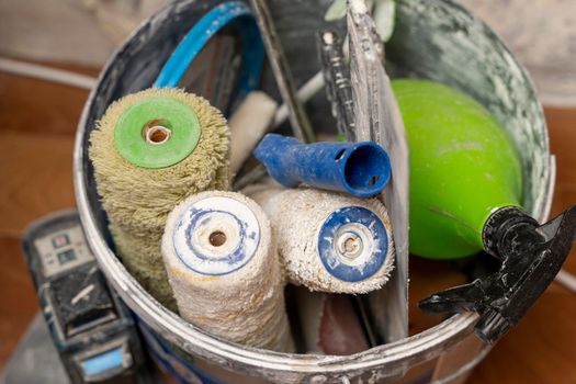 Various objects for painting works. Preparation for repair. roller for painting, paint bucket, spatula