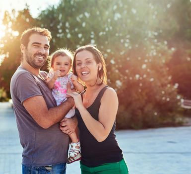 Enjoying the beautiful day outside. a young family outdoors