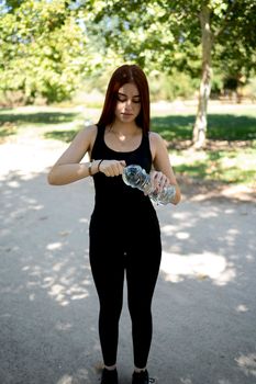 Sportsman with bottle of water outdoors in a public park, close-up. stock photography