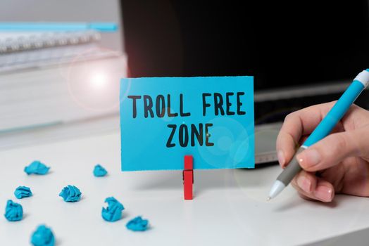 Text showing inspiration Troll Free Zone, Concept meaning Social network where tolerance and good behavior is a policy Businessman in suit holding open palm symbolizing successful teamwork.
