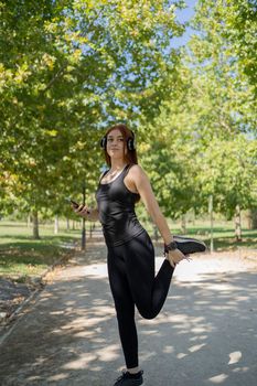 Portrait of fit and sporty young woman doing stretching in public park. stock photography