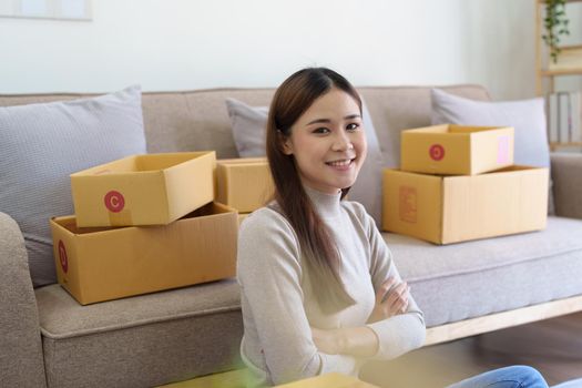 Portrait of Starting small businesses, two Asian woman check online orders Selling products working with boxs freelance work at home office, sme business concepts