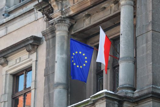 The flag of Poland and the European Union hangs on the building