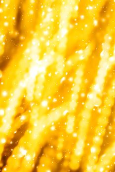 Golden Christmas lights, New Years Eve fireworks and abstract texture concept - Glamorous gold shiny glow and glitter, luxury holiday background