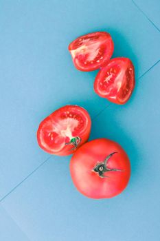 Plant based diet, vegetarian recipe and farm garden concept - Fresh ripe red tomatoes on blue background, organic vegetable food