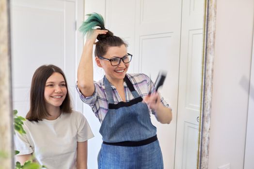 Haircut at home, mom cuts daughters hair, woman cuts dyed unhealthy hair, mother shows cut colored hair, girl happy with new haircut