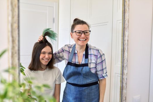 Haircut at home, mom cuts daughters hair, woman cuts dyed unhealthy hair, mother shows cut colored hair, girl happy with new haircut