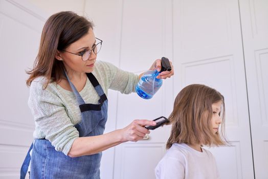 Mother cutting hair to daughter at home, children, hairstyles, hair, beauty.