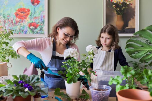 Mother and daughter child plant potted plants, flowers. Hobbies and leisure, care, family, houseplant, home potted friends concept