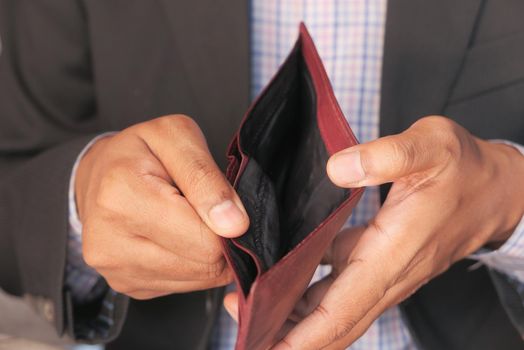 Man hand open an empty wallet with copy space