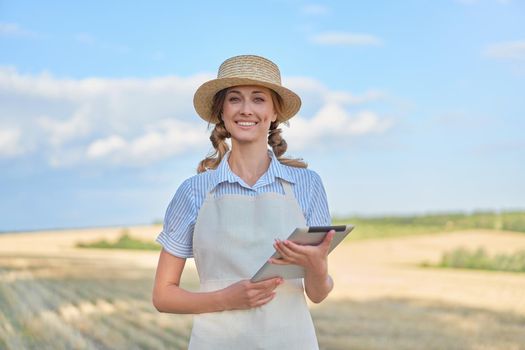 Woman farmer straw hat smart farming standing farmland smiling using digital tablet Female agronomist specialist research monitoring analysis data agribusiness Caucasian worker agricultural field