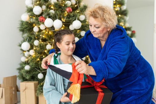 grandmother and granddaughter christmas with flag of united arab emirates at christmas.