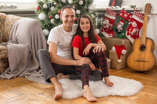 family, christmas, x-mas, happiness and people concept - smiling father and daughter