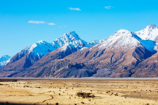 The Highway 80 road towards Mt Cook Village along Lake Pukaki on a clear spring day in Canterbury, New Zealand