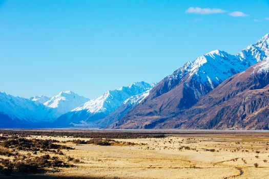 The Highway 80 road towards Mt Cook Village along Lake Pukaki on a clear spring day in Canterbury, New Zealand