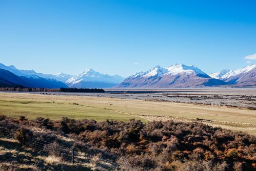 The Highway 80 road towards Mt Cook Village along Lake Pukaki on a clear spring day in Canterbury, New Zealand