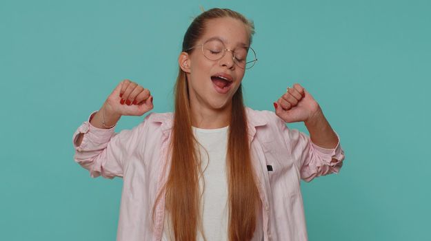 Tired overworked teenager young girl yawning, sleepy inattentive feeling somnolent lazy bored gaping suffering from lack of sleep. Bored student child kid isolated on blue studio background indoors