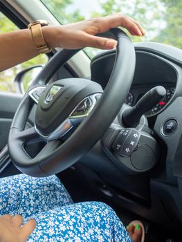 Beautiful business lady driving her car a cloudy day in summertime