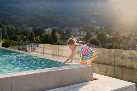 Girl near the pool at a hotel in the Alps