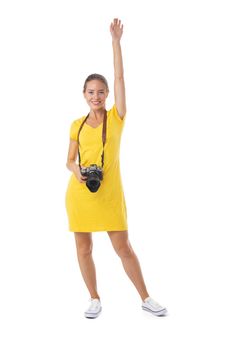 Young beautiful photographer girl in yellow dress with camera isolated on white background