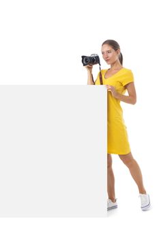 Young photographer girl with cameraand blank banner ad isolated white background