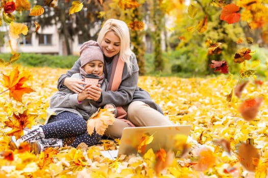 Happy family on autumn walk Mother and daughter walking in the Park and enjoying the beautiful autumn nature. High quality photo