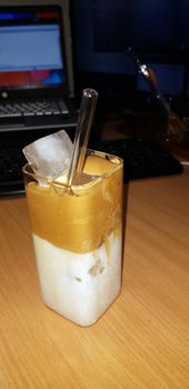 refreshing drink Ice Dalgona Coffee a trendy fluffy frothy creamy whipped coffee served in a korean square glass very refreshing drink and beverage
